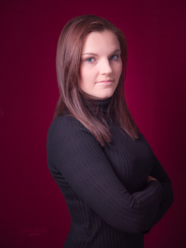 Portrait einer Jungen hübschen Frau mit rotem Hintergrund